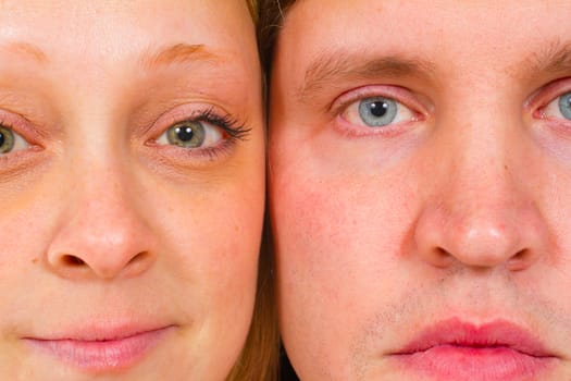 An attractive couple is photographed for a studio portrait on a white background.