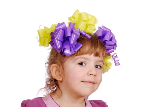 Beauty little girl with colorful ribbons on hair studio shot