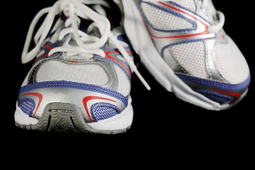 Pair of athletic shoes isolated on black background