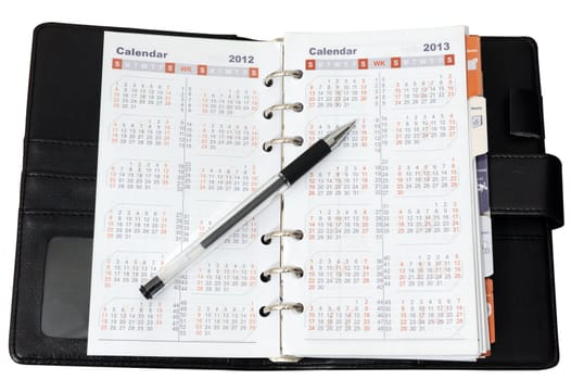 Calendar in notebook with a pen on it