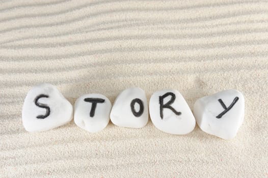 Story word carved on stones of the beach