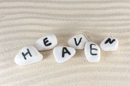 Heaven word on group of stones with sand as background