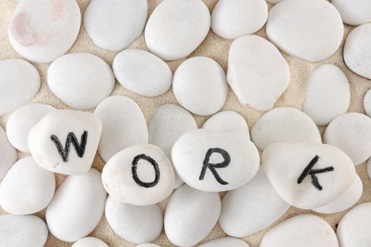 Work word among group of stones on the sand