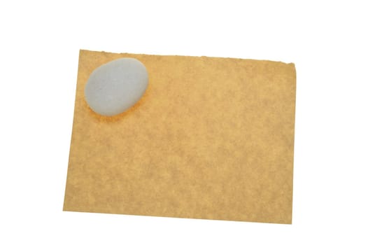 Blank old paper with a pebble on it isolated on white background