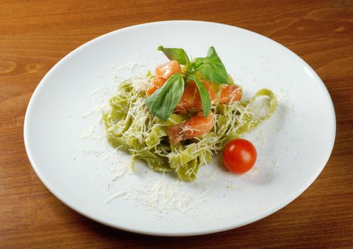 Pasta tagliatelle with pesto sauce basil and salmon