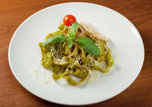 Pasta tagliatelle with pesto sauce basil and grated parmesan