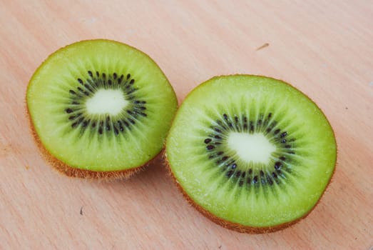 Fresh kiwis on wooden ground