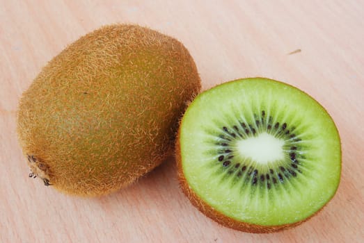Fresh kiwis on wooden ground