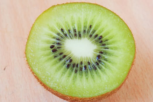 Fresh kiwis on wooden ground
