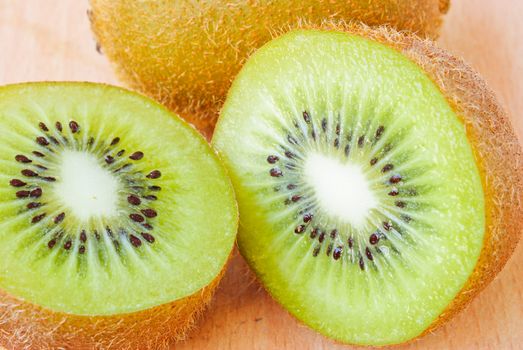 Fresh kiwis on wooden ground