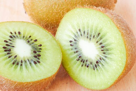 Fresh kiwis on wooden ground