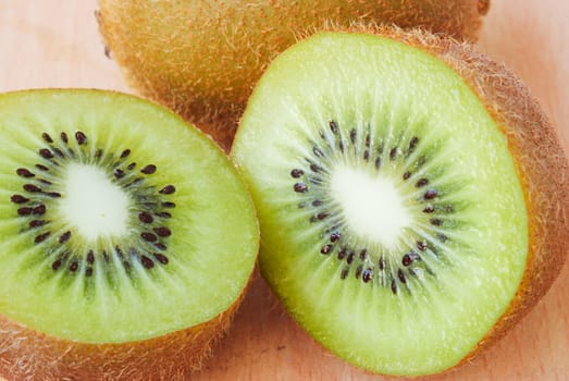 Fresh kiwis on wooden ground