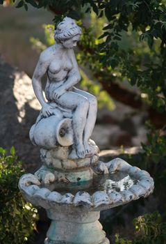Park garden fountain statue of a woman with a jug of water