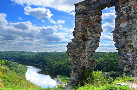 Ruined castle on a high hill in the woods and rivers