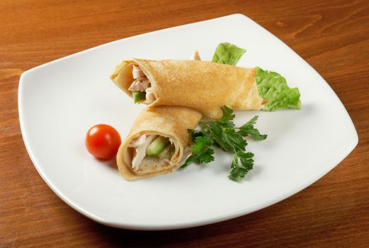 rolled pancakes stuffed chicken. Shallow depth-of-field.