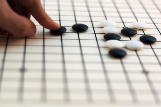 Hand making move on Traditional Chinese Board Game - Go