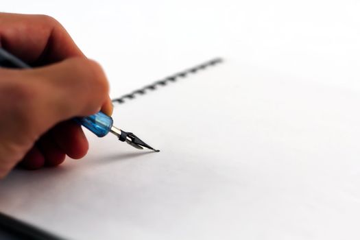 Writing on the notebook with pen