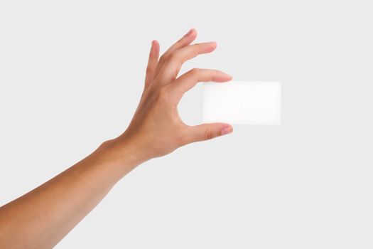 Female Hand Holding a Blank Business Card. Isolated on light grey background.