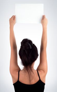 Young Casual Woman Face Back Holding a Blank Signboard - Paper with her two hands, isolated on light grey background