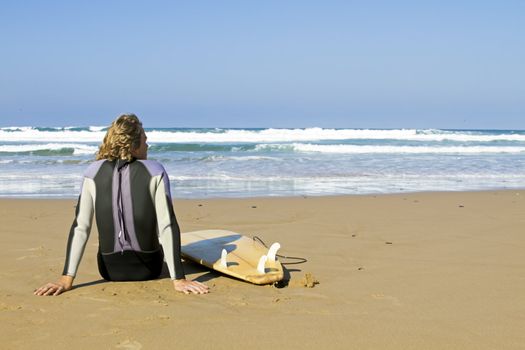 Surfer with his surfboard at the beach