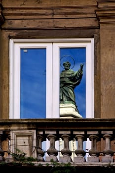 a statue of a saint in a window in naples