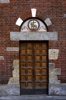 one of the door in the church of san babila in milan