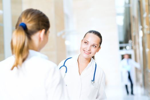 two doctors talking in the lobby of the hospital,