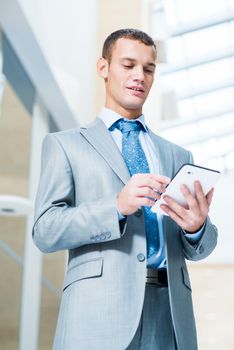 businessman running in the Tablet PC in the office