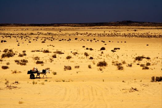 two people in the desert of tunisia in a truck