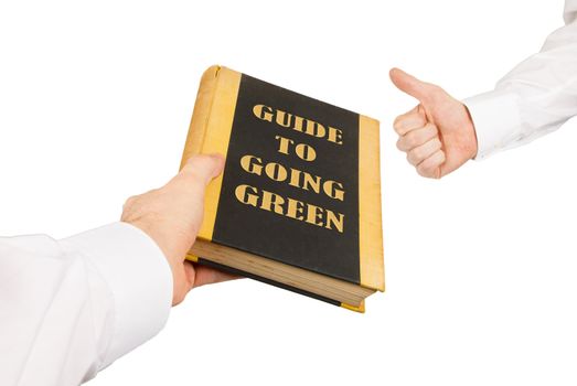 Businessman giving an used book to another businessman, guide to going green