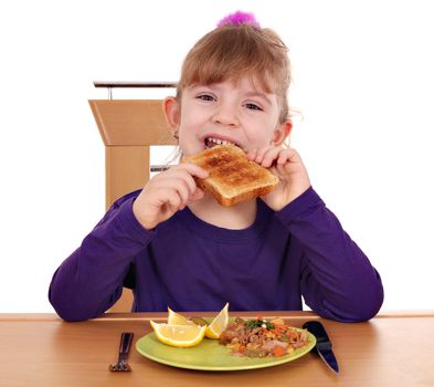 hungry little girl eating bread