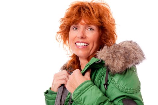 adult redhead woman with winter jacket smiling isolated on white background