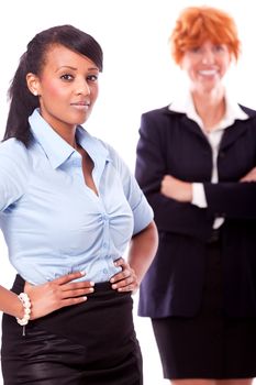 happy young african business woman and female team in background isolated on white background