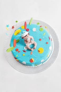 Studio shot of blue birthday cake on light background