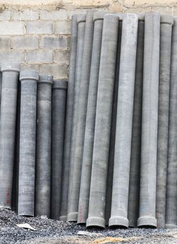 Stack of many concrete drainage pipe on wall  in construction site