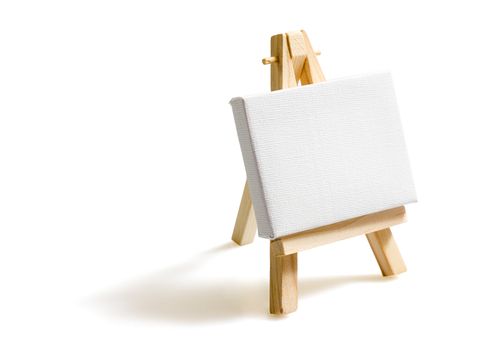 Empty blank canvas on wooden easel isolated on white background