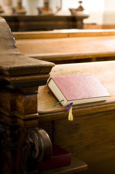 Closed bible on a wooden bench