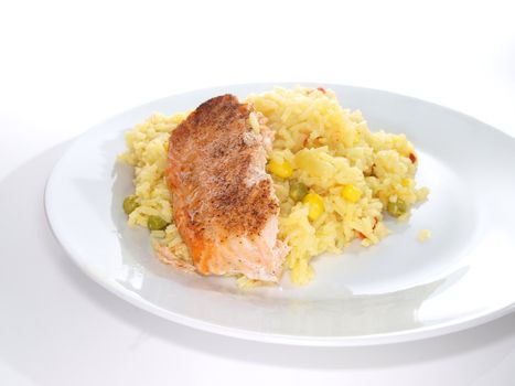 Grilled salmon fish piece, on a plate towards white