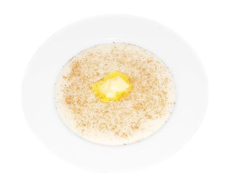 Porridge in a deep bowl with butter eye, cinnamon and sugar