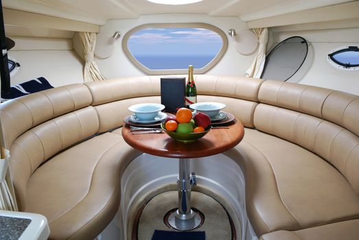 Luxury yacht cabin interior with fruits and champagne