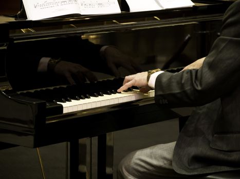 Male hands playing piano. Horizontal shape, copy space 