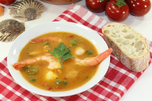 a bowl of bouillabaisse with shrimp and mussels