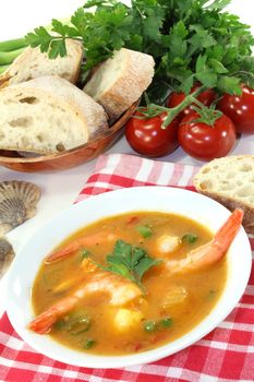 a bowl of bouillabaisse with shrimp and mussels