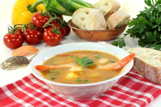 a bowl of bouillabaisse with shrimp and mussels