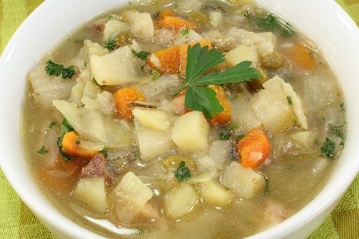 a bowl of cabbage soup and fresh parsley