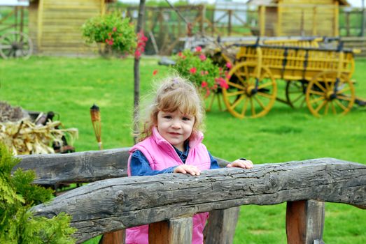 Little girl on the country outdoor scene