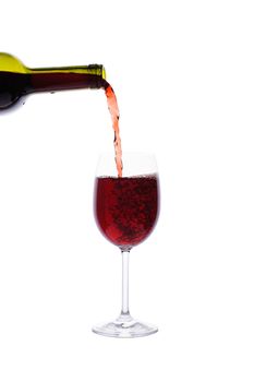 Red wine pouring into wine glass isolated on white background