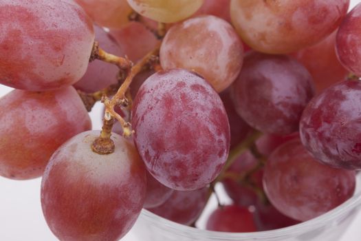 Fresh red grapes on white background