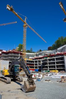 Picture of a construction site with cranes and other machines