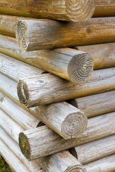 A corner joint of a log cabin made with natural materials shows the construction of the building.